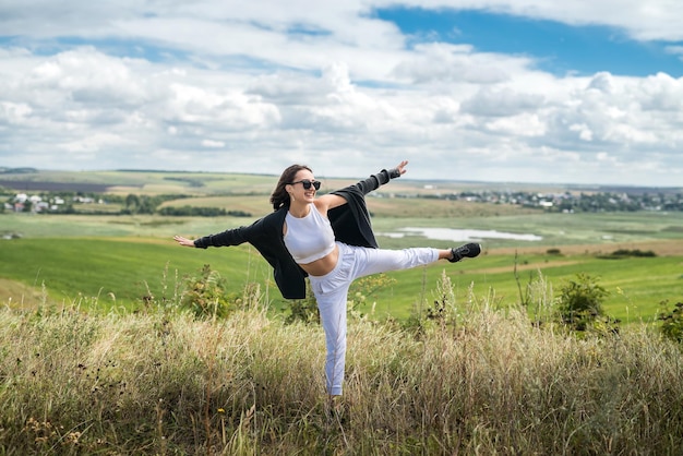 Young Ukrainian woman walks on a warm summer day in the field