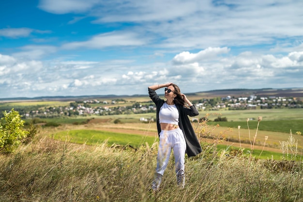 Young Ukrainian woman walks on a warm summer day in the field