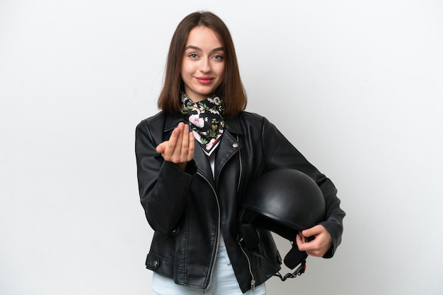 Young Ukrainian woman with a motorcycle helmet isolated on white background inviting to come with hand Happy that you came