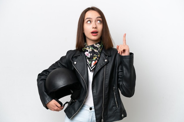 Young Ukrainian woman with a motorcycle helmet isolated on white background thinking an idea pointing the finger up