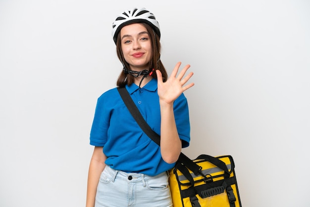 Young Ukrainian woman with thermal backpack isolated on white background counting five with fingers