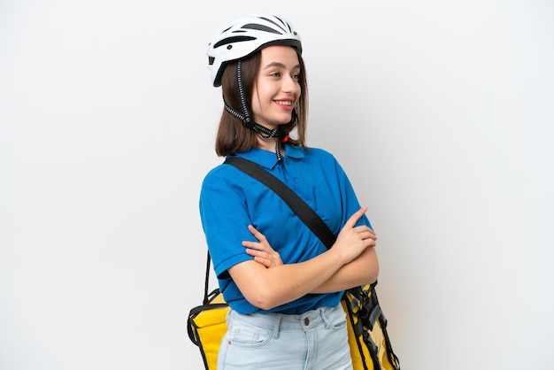 Young Ukrainian woman with thermal backpack isolated on white background in lateral position