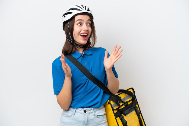 Young Ukrainian woman with thermal backpack isolated on white background with surprise facial expression