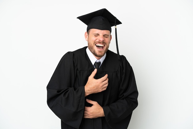 Young university Brazilian graduate isolated on white background smiling a lot