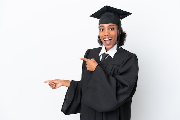 Young university graduate African American woman isolated on white background surprised and pointing side