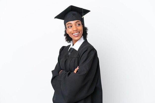 Young university graduate African American woman isolated on white background with arms crossed and happy