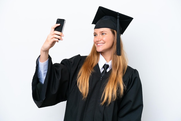 Young university graduate caucasian woman isolated on white background making a selfie