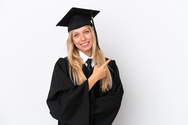 Young university graduate caucasian woman isolated on white background pointing to the side to present a product