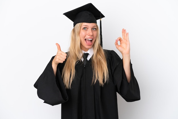 Young university graduate caucasian woman isolated on white background showing ok sign and thumb up gesture