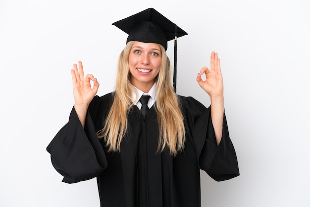 Young university graduate caucasian woman isolated on white background showing an ok sign with fingers