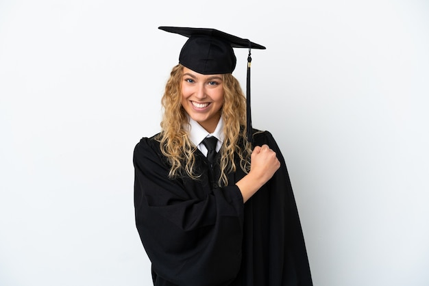 Young university graduate isolated on white background celebrating a victory