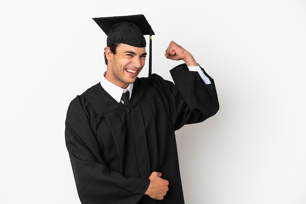 Young university graduate over isolated white background doing strong gesture