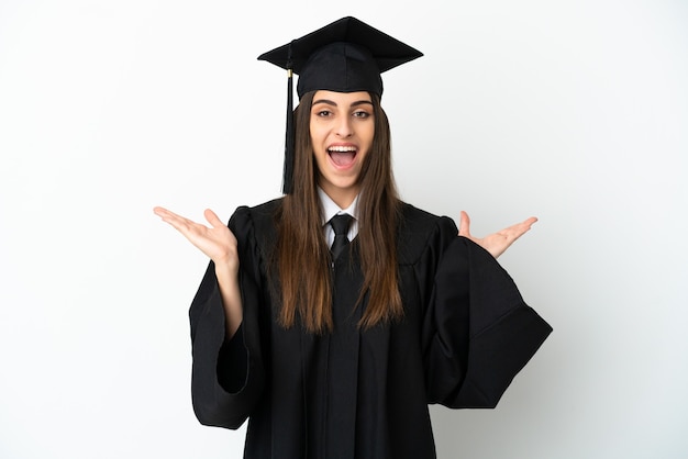 Young university graduate isolated on white background with shocked facial expression