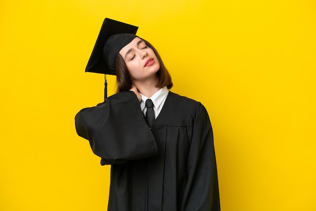 Young university graduate Ukrainian woman isolated on yellow background with neckache