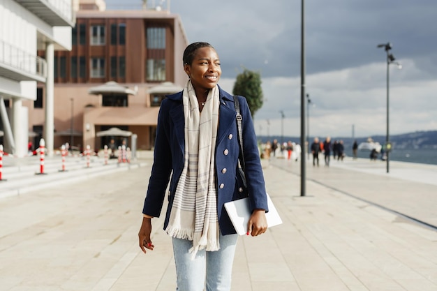 Young urban african woman walking in the city