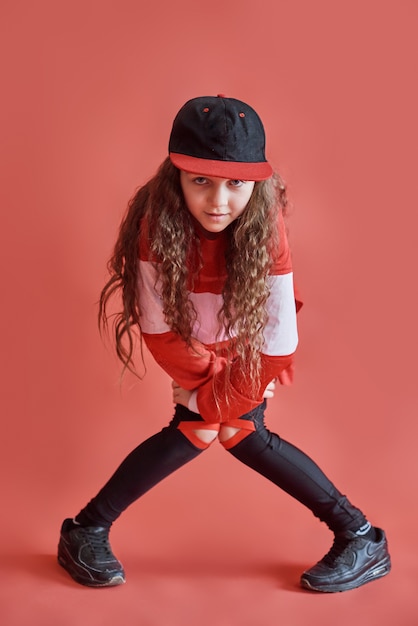 Young urban woman dancing, modern slim hip-hop style teenage girl