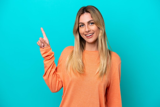 Young Uruguayan woman isolated on blue background showing and lifting a finger in sign of the best