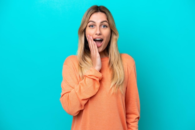 Young Uruguayan woman isolated on blue background with surprise and shocked facial expression