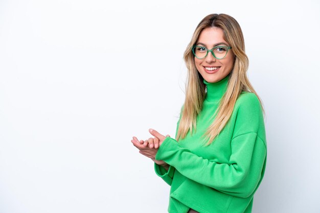 Young Uruguayan woman isolated on white background applauding