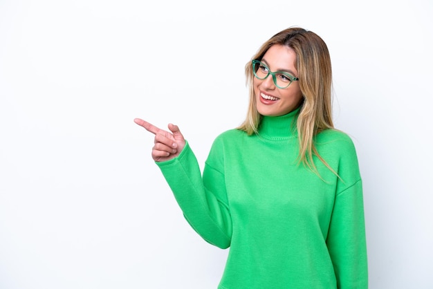 Young Uruguayan woman isolated on white background pointing finger to the side and presenting a product