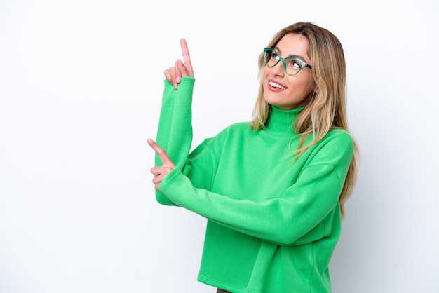 Young Uruguayan woman isolated on white background pointing with the index finger a great idea