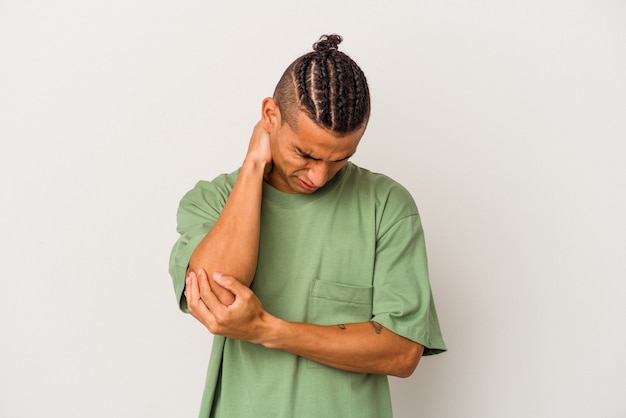 Young venezuelan man isolated on white background massaging elbow, suffering after a bad movement.