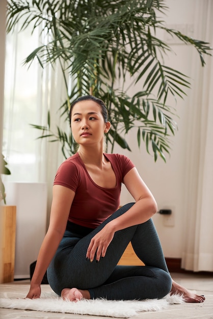 Young Vietnamese woman in haft twist pose