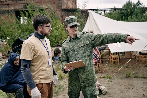 Young volunteers discussing improvement measures in refugee camp