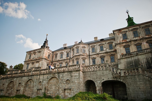 Young wedding couple on background old castle