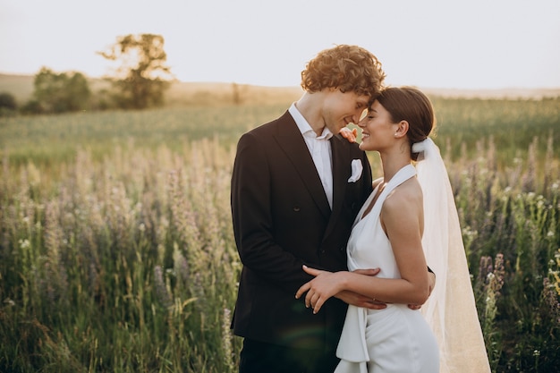 Young wedding couple together in field