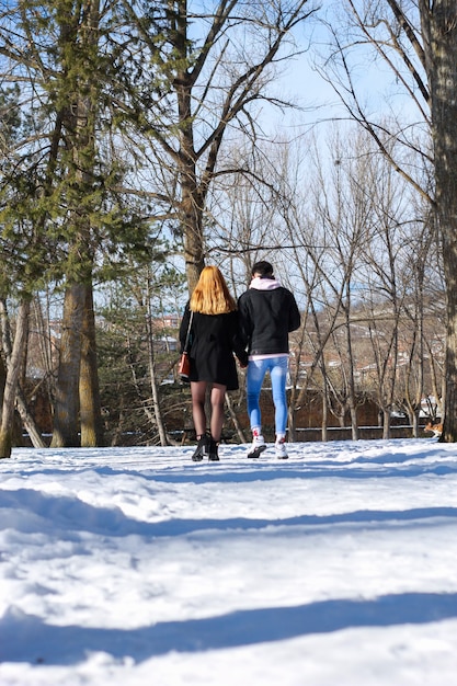 Young wedding couple walking in the snow