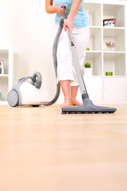 a young wife hoovering her apartment