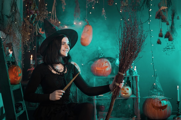 Young witch conjures during Halloween at home