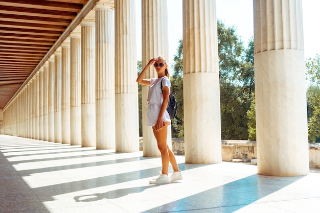 Young woman at the ancient greek ruins