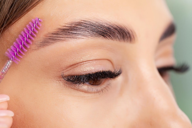 Young woman applied mascara to her lashes