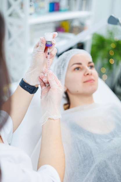 A young woman at an appointment with a beautician beauty injections for the face Treatment procedure at a dermatologist