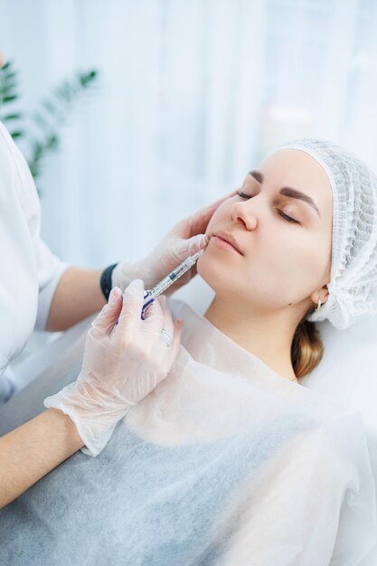 A young woman at an appointment with a beautician beauty injections for the face Treatment procedure at a dermatologist