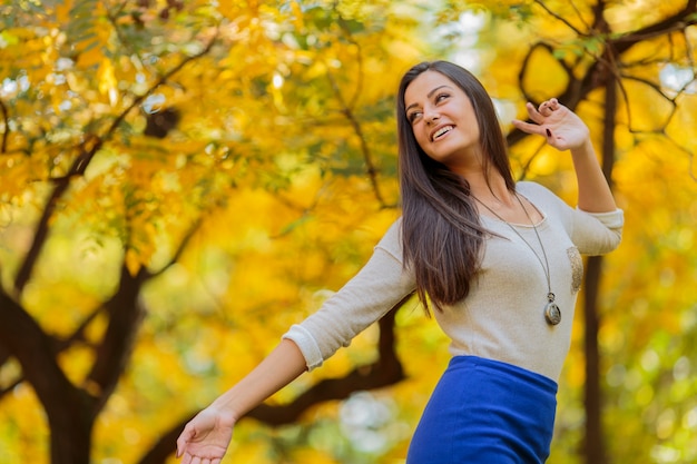 Young woman in the autumn forest