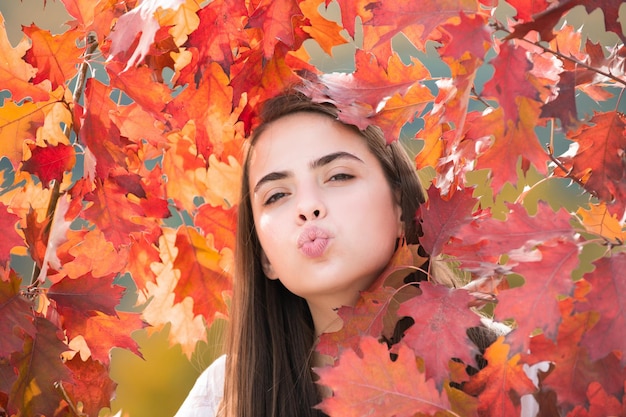 Young woman in autumn park warm sunny weather fall concept hello autumn happy woman with autumn yell