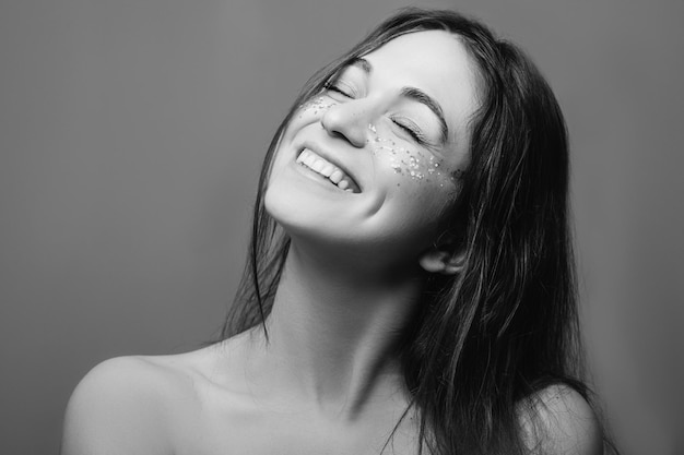 Young woman beauty Perfect fresh skin Toothy smile Cheek dimples Black and white portrait