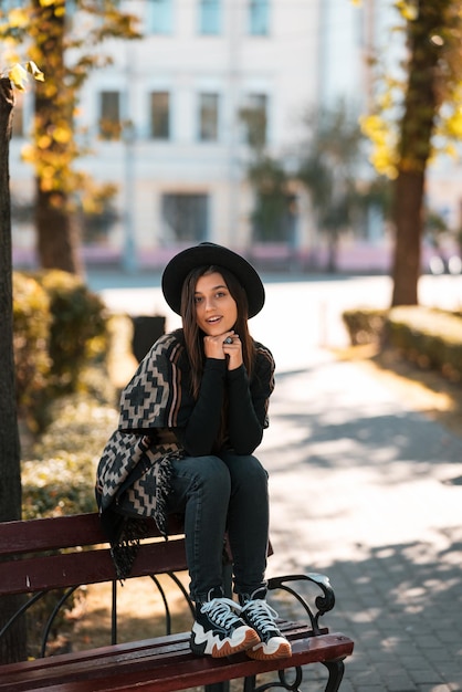 Young woman on a bench in the autumn park