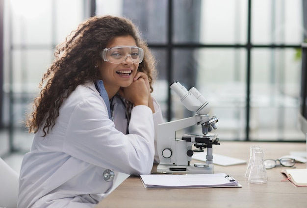 Young woman in biological laboratory Attractive young female scientis