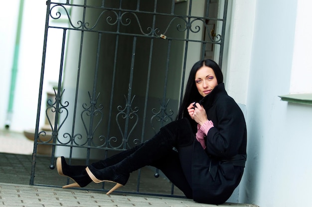 Young woman in a black coat outdoors cold weather City portrait