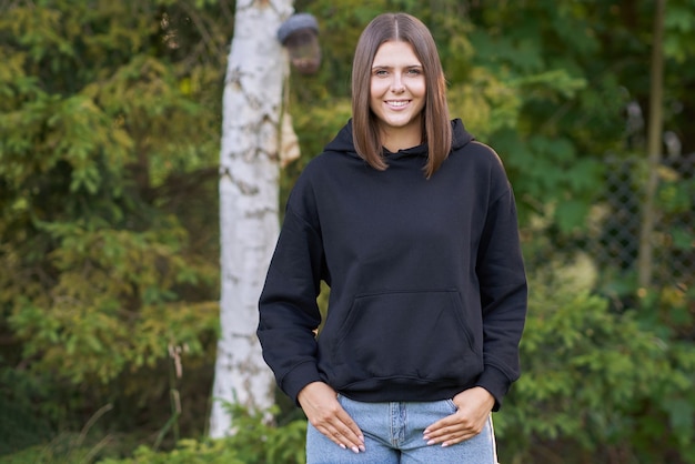 Young woman in black hoodie. High quality photo