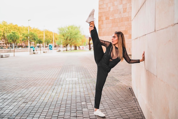 Young woman in black suit taking selfie on street