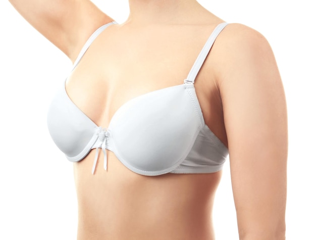 Young woman in bra on white background