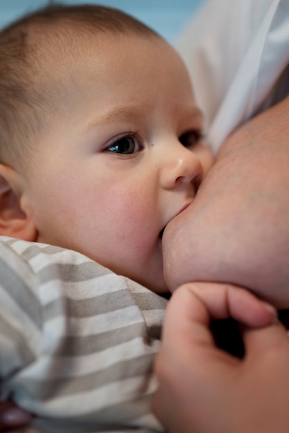 Young woman breastfeeding her cute baby