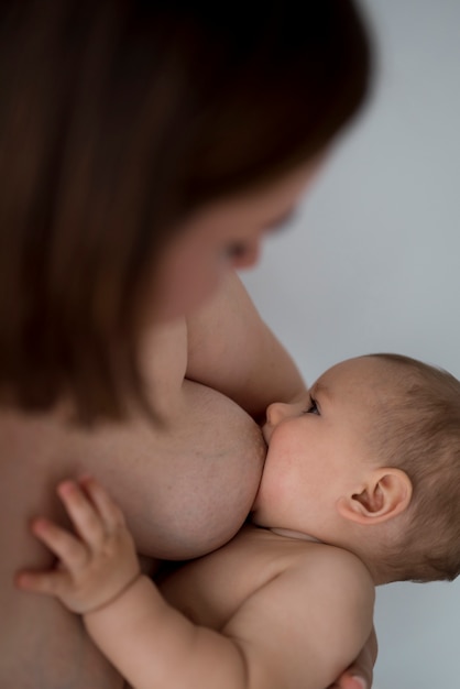 Young woman breastfeeding her cute baby