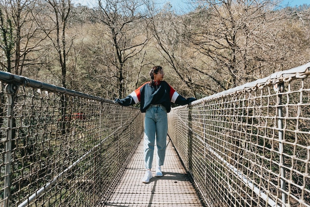 A young woman in a bridge over a river