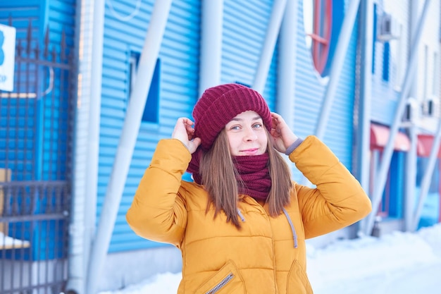 Young woman in bright clothes walks outside on a winter day